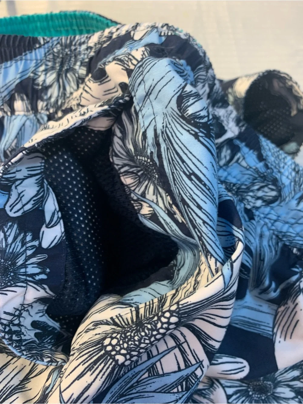 No Boundaries swim trunks feature a distinctive skull and floral pattern. SZ L